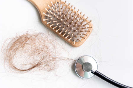 Top view of a brush with lost hair on it, hair fall everyday serious problem. Isolated on white...
