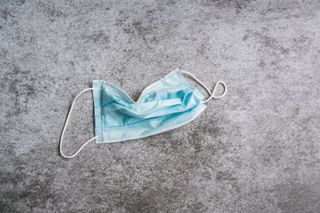 Flat lay of used medical face masks on black and white background. Close upの写真素材