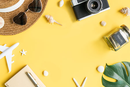 Flat lay travel accessories on yellow background. Travel, summer vacation concept. Copy space for text, top viewの写真素材