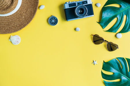 Flat lay travel accessories on yellow background. Holiday, summer vacation concept. Copy space for text, top viewの写真素材