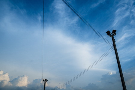 electric cable and electric pole with blue sky and white cloudの写真素材