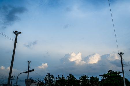 electric cable and electric pole with blue sky and white cloudの写真素材