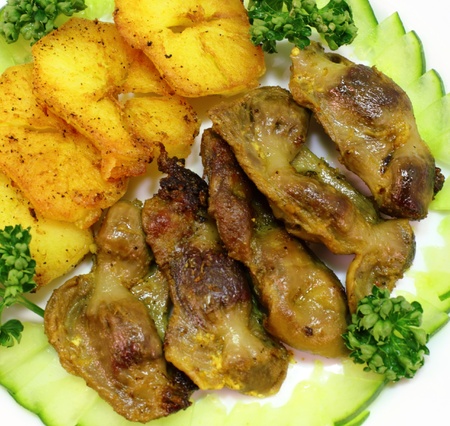 fried chicken gizzards, presented with grilled potatoes and vegetables の写真素材