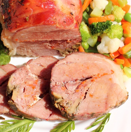 roasted pork roll with mushrooms and vegetablesの写真素材