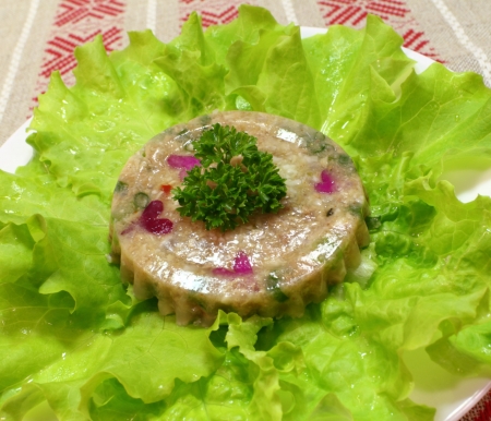 meat jelly snack with salad leaf on white plateの写真素材