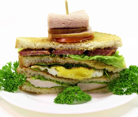 big sandwich with chicken breast, fried egg, ham and vegetables の写真素材
