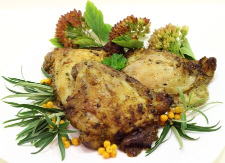 it is fried chicken thighs with sea-buckthorn on a white plate の写真素材
