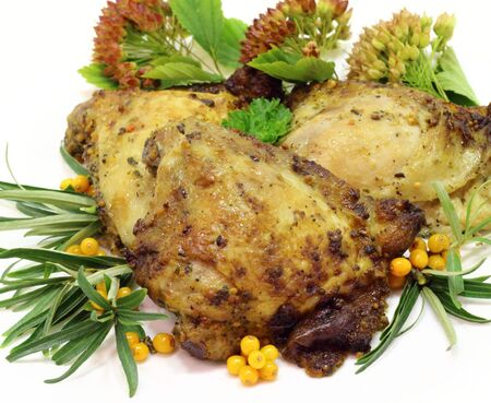 it is fried chicken thighs with sea-buckthorn on a white plate の写真素材