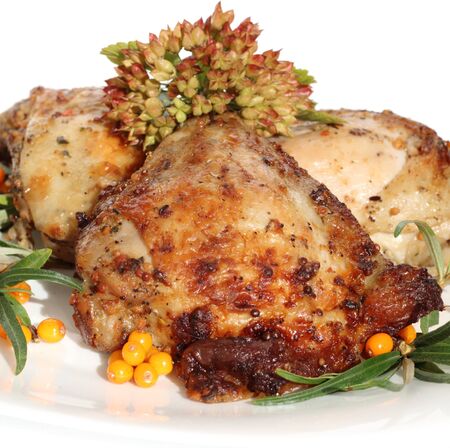 it is fried chicken thighs with sea-buckthorn on a white plate の写真素材