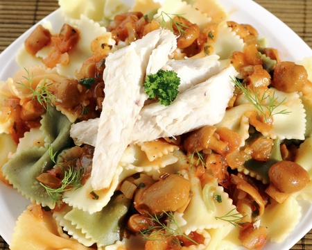 Smoked fish fillet served with pasta and sauce with mushroomsの写真素材