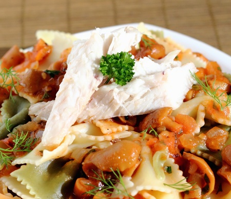 Smoked fish fillet served with pasta and sauce with mushroomsの写真素材