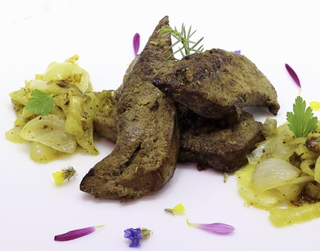 Fried pork liver with caramelized onions a white plateの写真素材