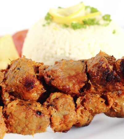 Grilled pork, served with rice and lemon の写真素材
