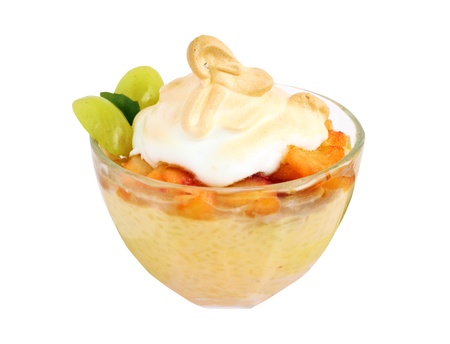 A glass bowl of rice pudding with fruit on a white background の写真素材