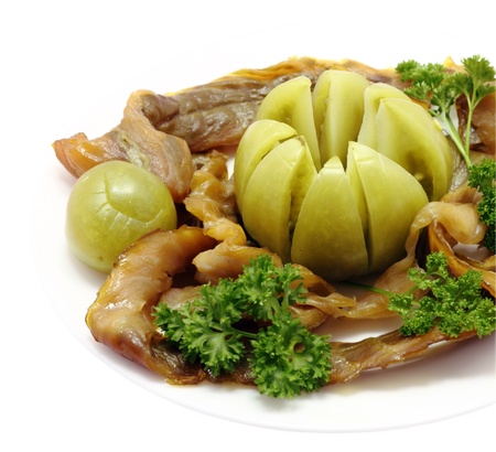Smoked salmon cutouts serving plate with pickled green tomato and parsleyの写真素材