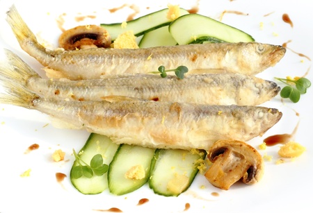 Freshly fried smelt served with cucumber stripsの写真素材