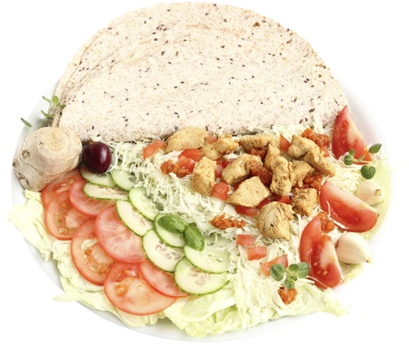 Fried savory chicken breast slices  with vegetables and tortilla on a white backgroundの写真素材
