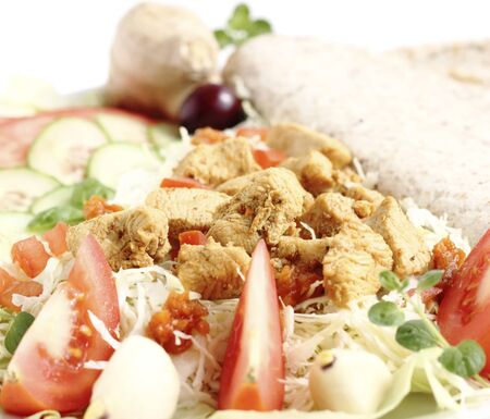 Appetizer with fried chicken breast sliced vegetables and tortilla の写真素材