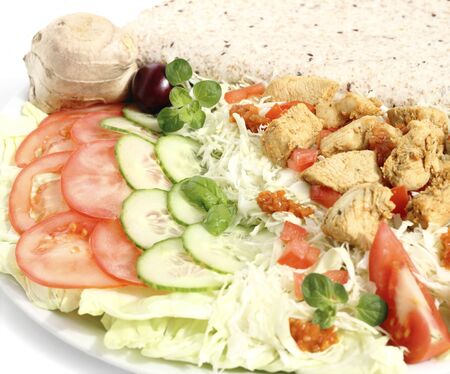 Appetizer with fried chicken breast sliced vegetables and tortilla の写真素材
