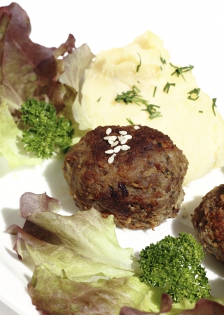 Roast rissoles served with mashed potatoes and lettuceの写真素材