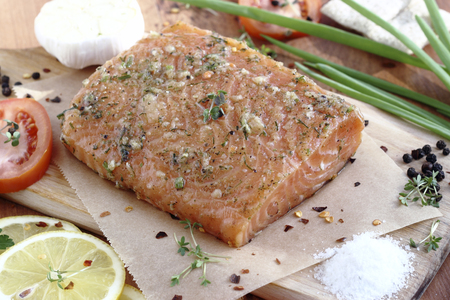 Close up  fresh salted salmon fillet with spicesの写真素材