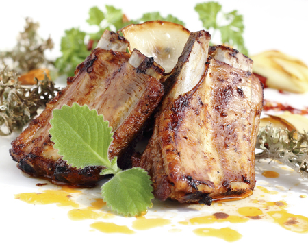 Close up of grilled pork ribs served with fried onions and garlicの写真素材
