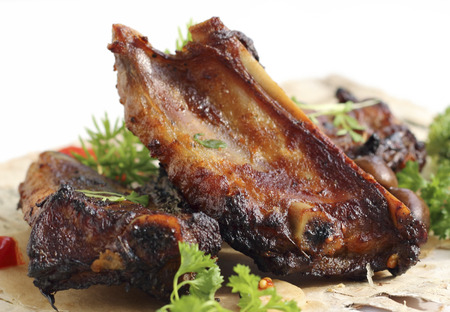 Close up grilled pork ribs with a green saladの写真素材