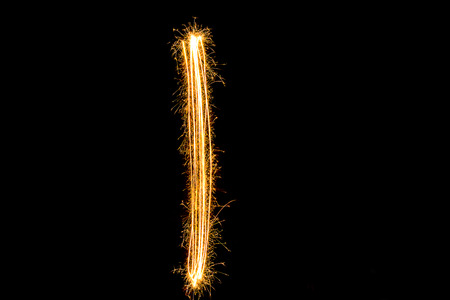 Sparkler firework light alphabet number 1 or 'I' text isolated on black background.の写真素材
