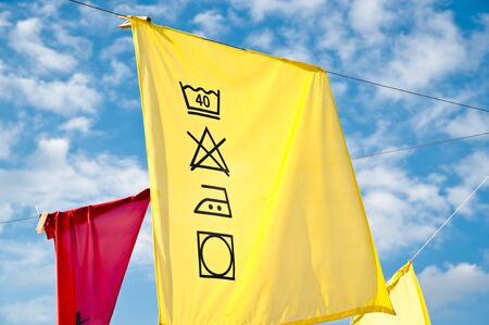 Cleaning symbols on a yellow clothの写真素材