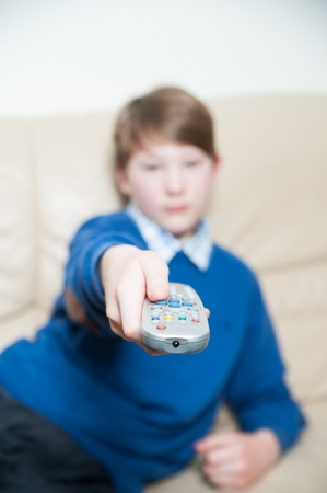 Boy with a Television Remote in his Handの写真素材
