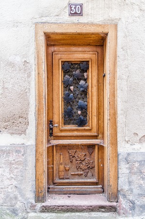 Antique Door with wine Ornament  in Alsaceの写真素材