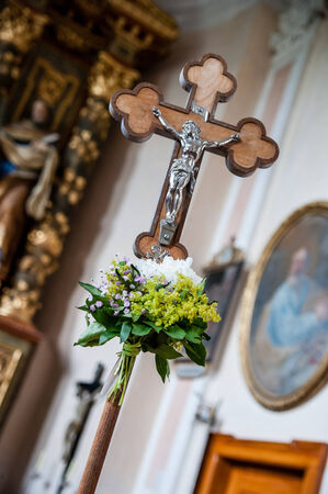 Cross with a flower bouquet in a Churchの写真素材