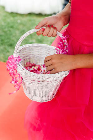 Flower girl with a basket of flower petalsの写真素材