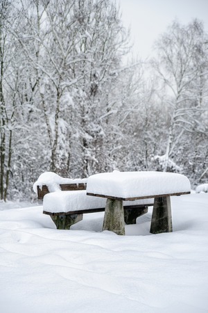 Service area with snowy bench and tableの写真素材
