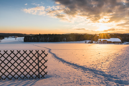 Beautiful winter landscape at sunset with farmhouse in upper austriaの写真素材