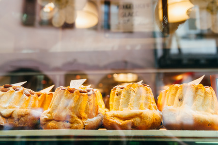 Bundt cakes behind a vitrine in a bakery shopの写真素材