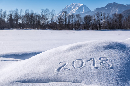Year 2018 written in Snow with Austrian Alps in the Background