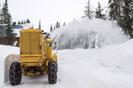 Yellow Snow Removal Machine Clearing Mountain Roadの写真素材
