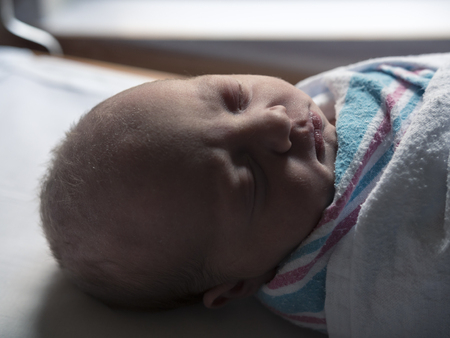 Close Up of Newborn Baby Napping in Hospital After Birthの写真素材