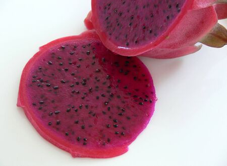 Deep pink, speckled flesh of the Pitaya or Dragon Fruit, Hylocereus. Isolated on whiteの写真素材