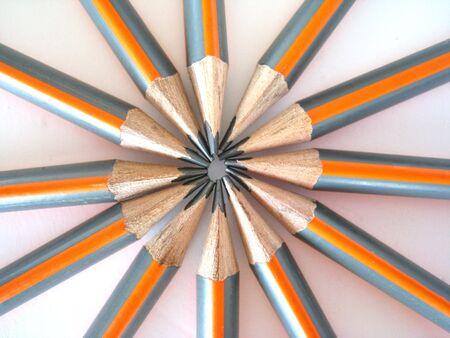 A ring of inward facing drawing pencils. Isolated on white.の写真素材