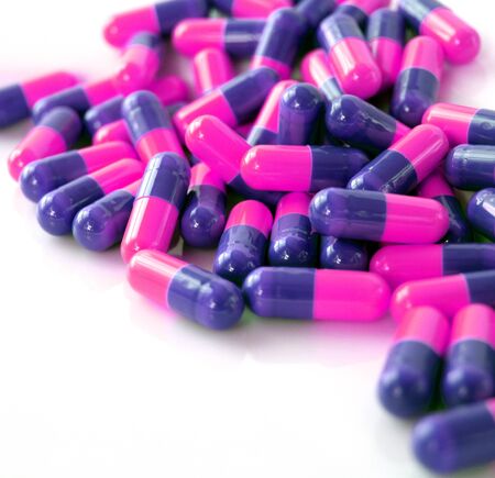 Colourful capsule tablets isloated on whiteの写真素材