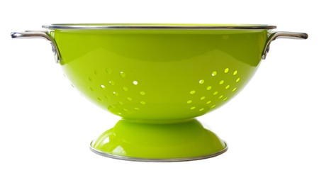 a bright green colander. Isolated on whiteの写真素材