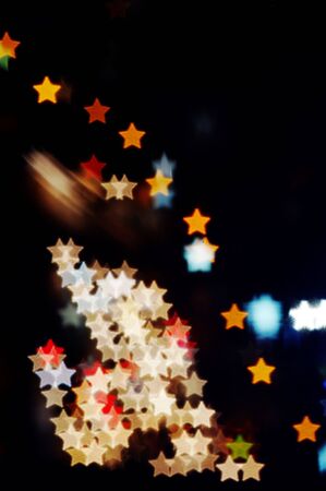 night lights blurred into star-shaped bokehの写真素材