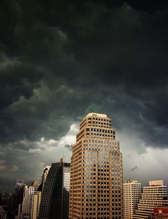 A dark and menacing sky over highrise buildings. Bangkok, Thailandの写真素材