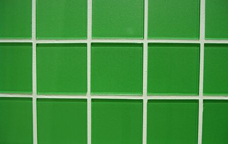 Edge-to-edge shot of square, green glass tiles. の写真素材