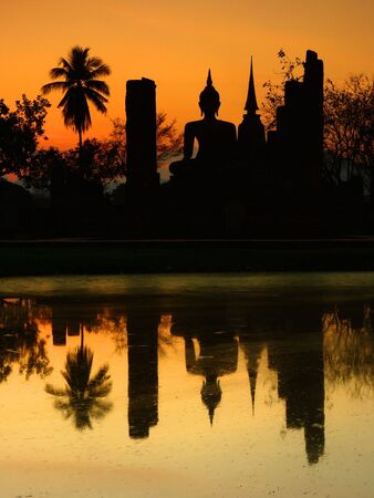 Silhouette of a Buddha at the Sukhothai Historical Park, Thailandの写真素材