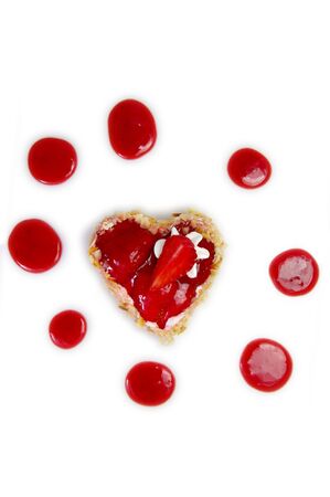 A delicious heart-shaped Strawberry Cheesecake. Overhead shot on white.の写真素材