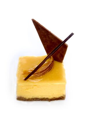 An elaborately decorated Mango and Burnt Orange Slice. Shot on whiteの写真素材