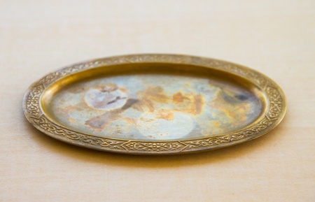 Old brass tray on on the plywoodの写真素材